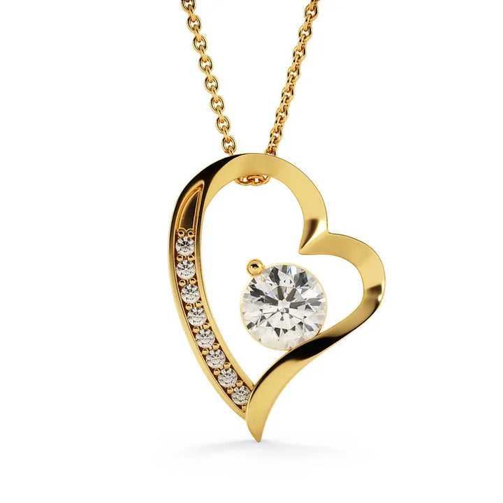 Gold heart-shaped necklace with a diamond on a white background