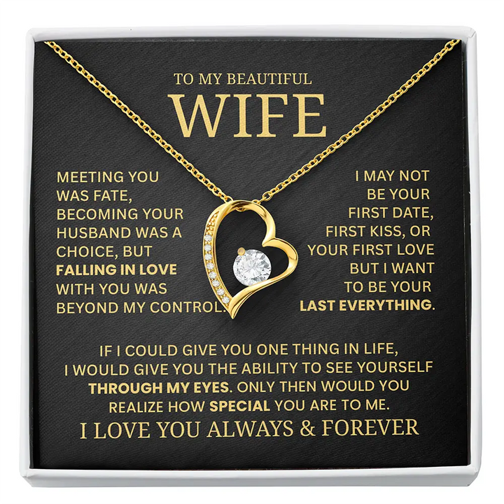 Gold necklace with heart design on a black card with gold text for a wife